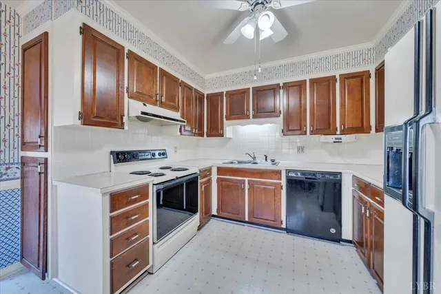 a kitchen with stainless steel appliances granite countertop a stove top oven a sink dishwasher a refrigerator and cabinets with wooden floor