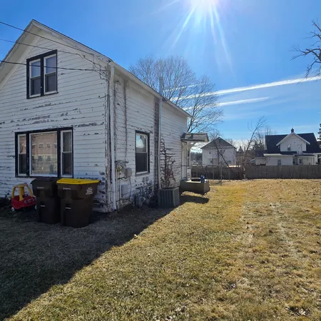 a view of a house with backyard and sitting area