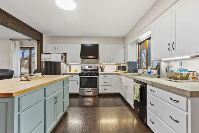a kitchen with a sink cabinets and stainless steel appliances