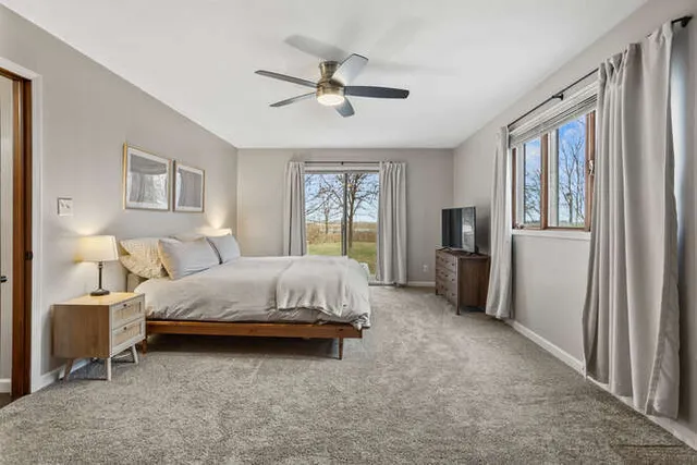 a spacious bedroom with a bed and a chandelier
