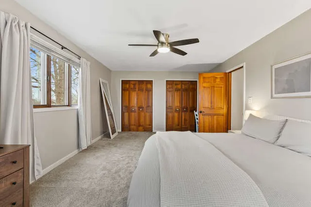 a bedroom with a large bed and window