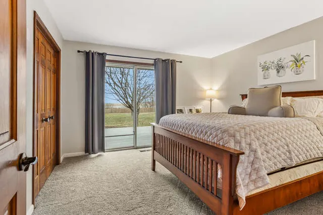 a bedroom with a bed and a large window