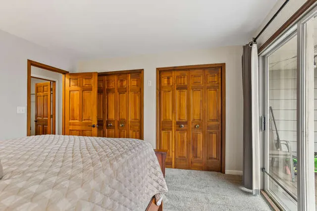 a bedroom with a bed and a chair