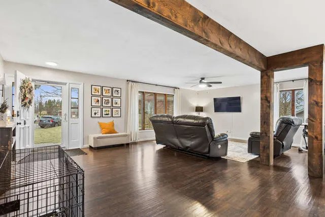 a living room with furniture and a wooden floor