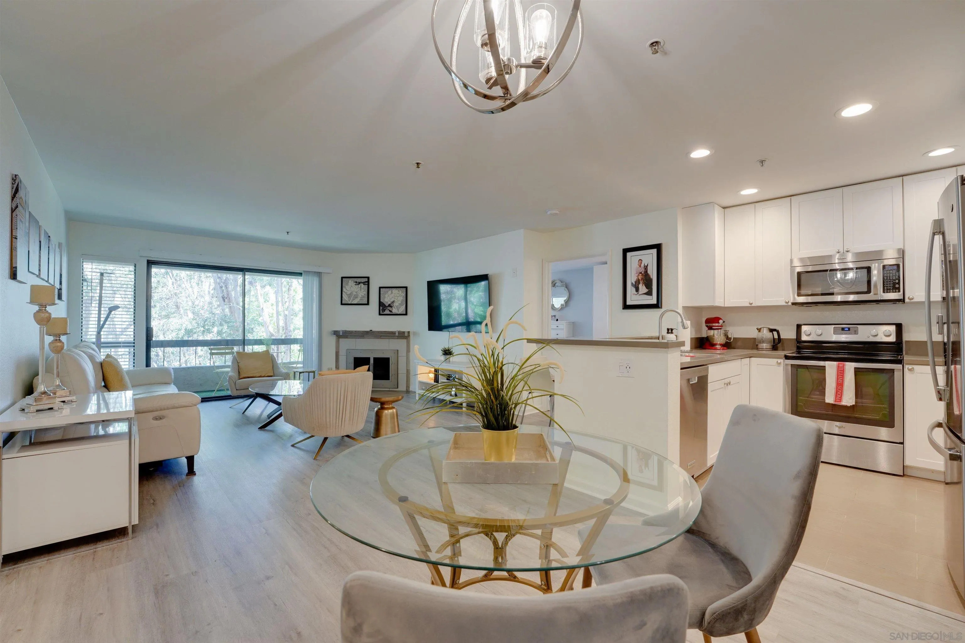 5745 Friars Road, Unit 107 San Diego, CA 92110 - Photo 1 of 25 a living room with fireplace furniture and a large window