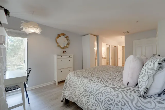 a spacious bedroom with a bed and a window