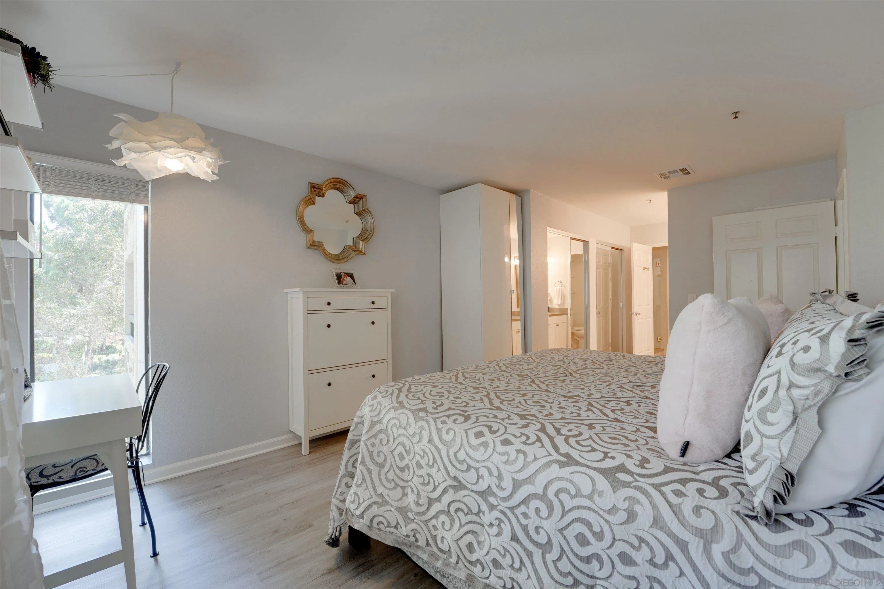 5745 Friars Road, Unit 107 San Diego, CA 92110 - Photo 12 of 25 a spacious bedroom with a bed and a window
