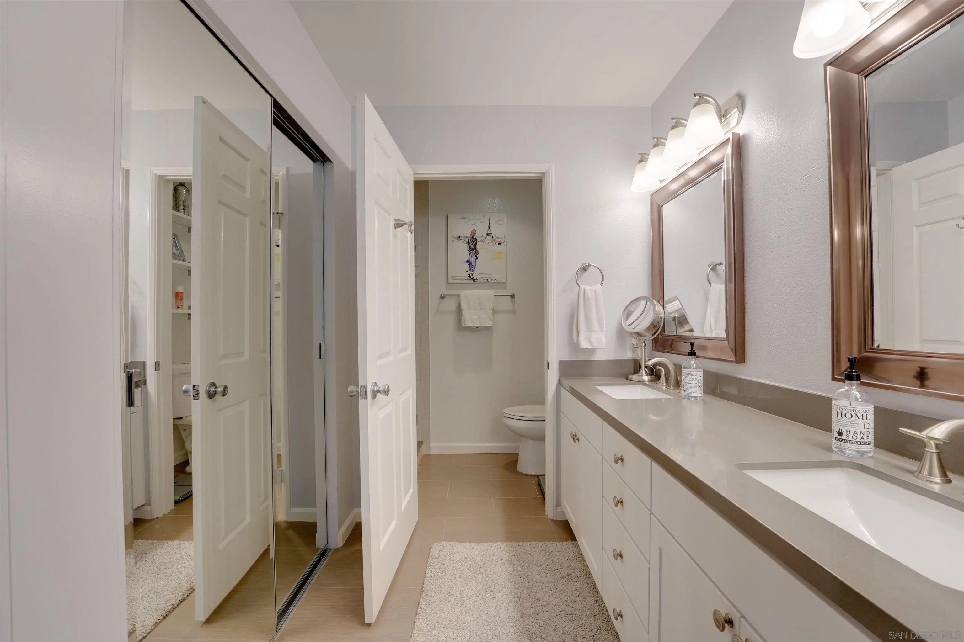 5745 Friars Road, Unit 107 San Diego, CA 92110 - Photo 15 of 25 a spacious bathroom with a double vanity sink a mirror and a shower