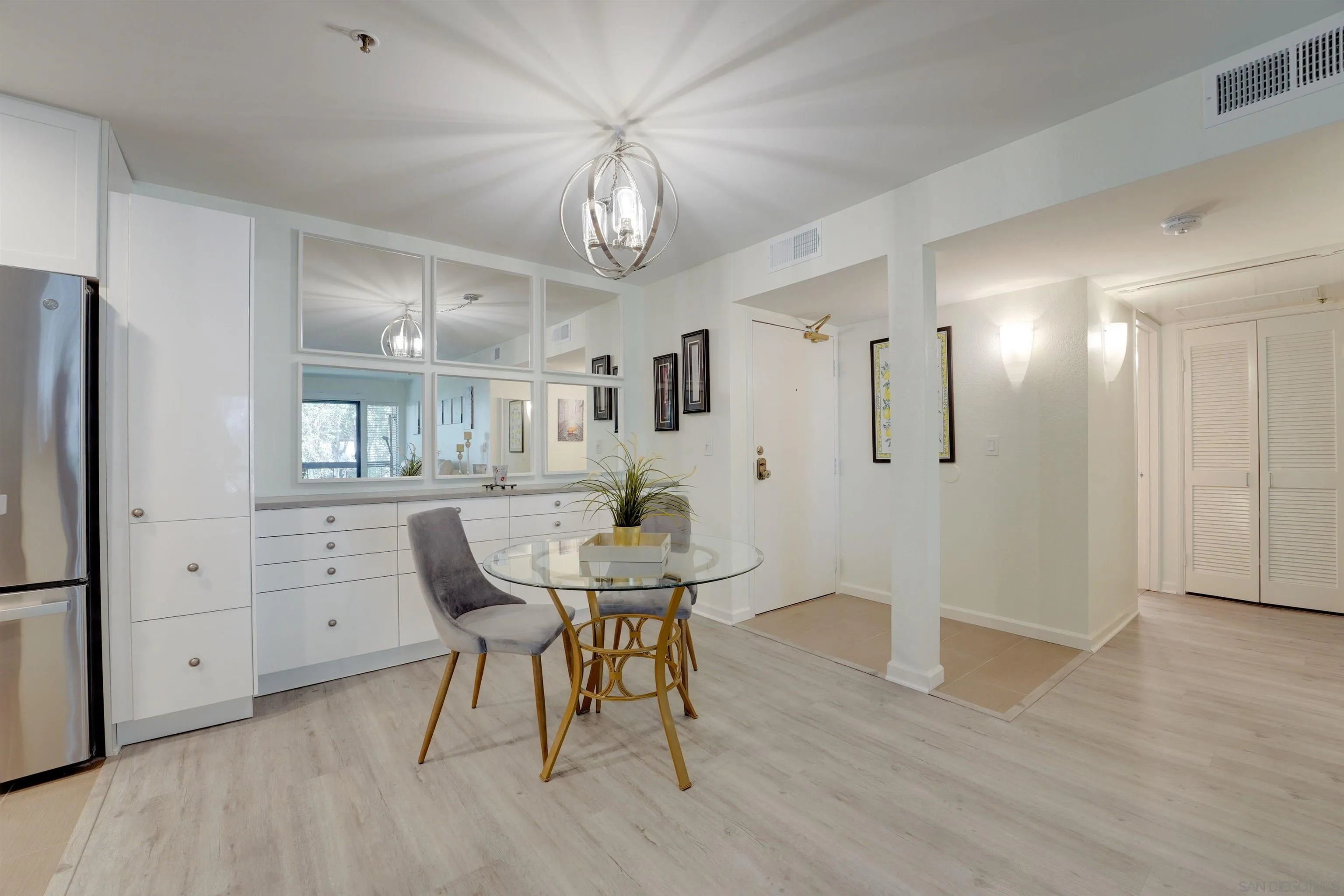5745 Friars Road, Unit 107 San Diego, CA 92110 - Photo 21 of 25 a view of a dining room with furniture and wooden floor