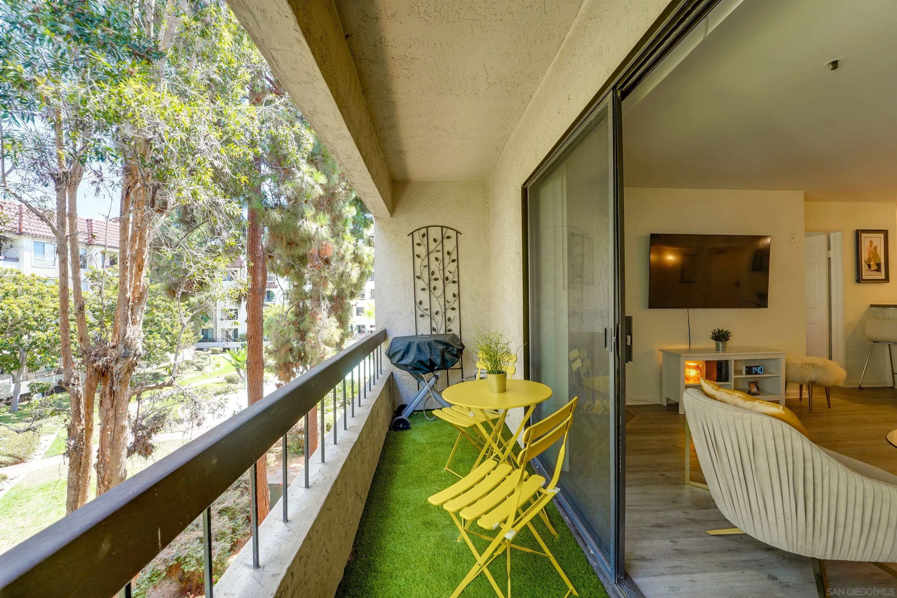 5745 Friars Road, Unit 107 San Diego, CA 92110 - Photo 23 of 25 a living room with furniture and a flat screen tv