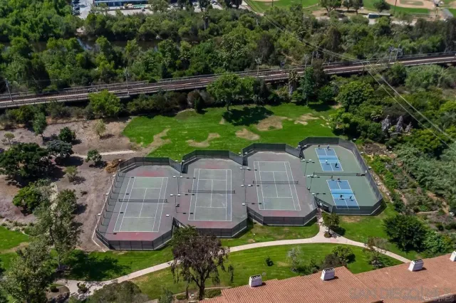 an aerial view of a house with a garden and outdoor seating