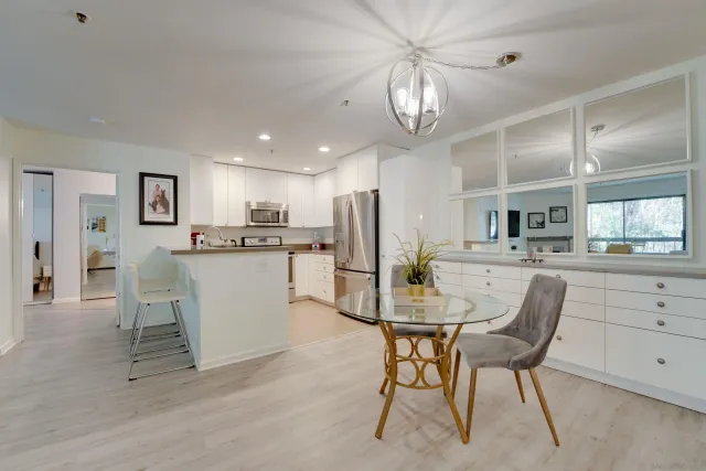 a view of kitchen and dining area with a sink