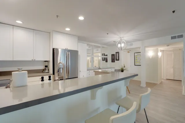 a kitchen with kitchen island granite countertop a sink and cabinets