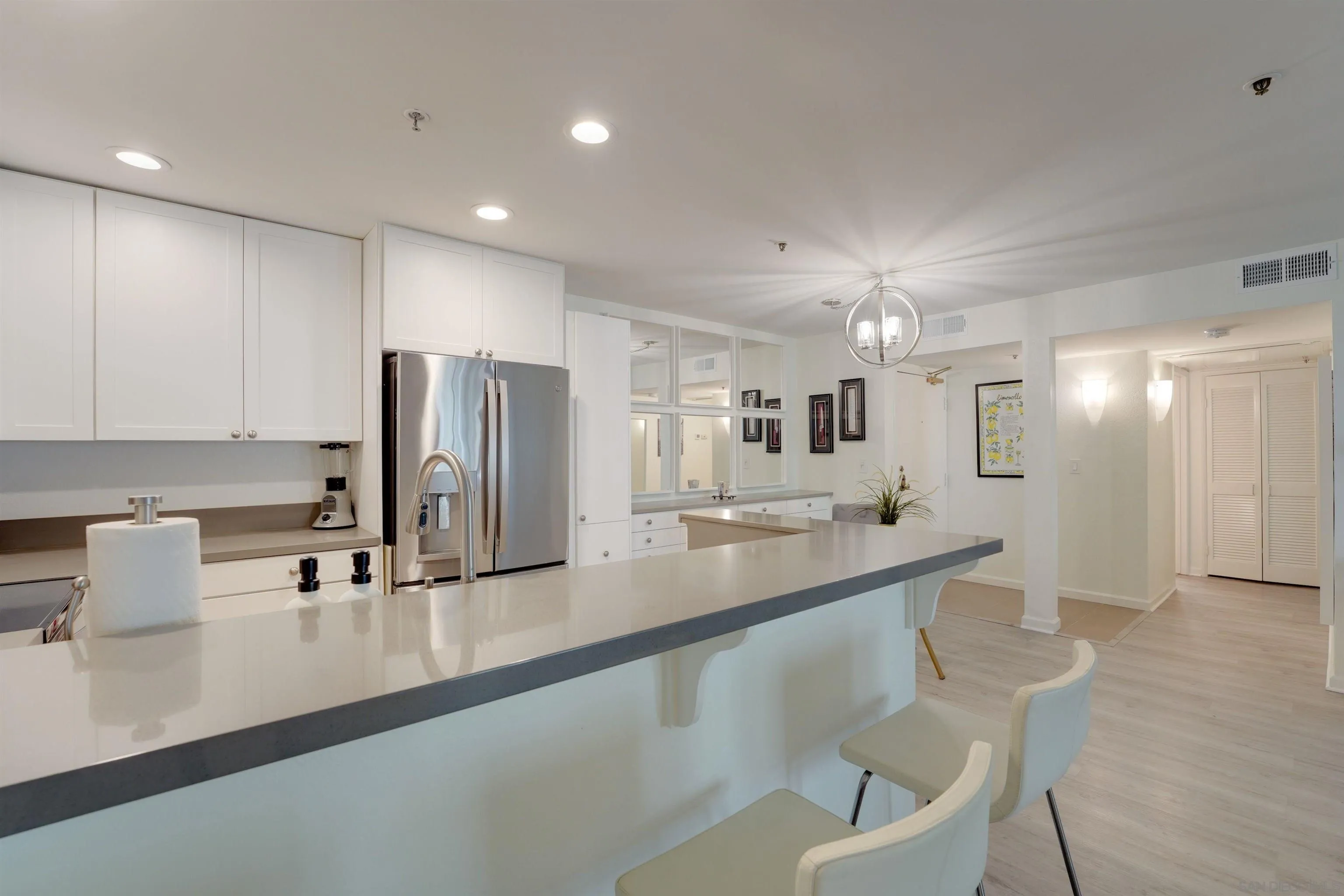 5745 Friars Road, Unit 107 San Diego, CA 92110 - Photo 5 of 25 a kitchen with kitchen island granite countertop a sink and cabinets