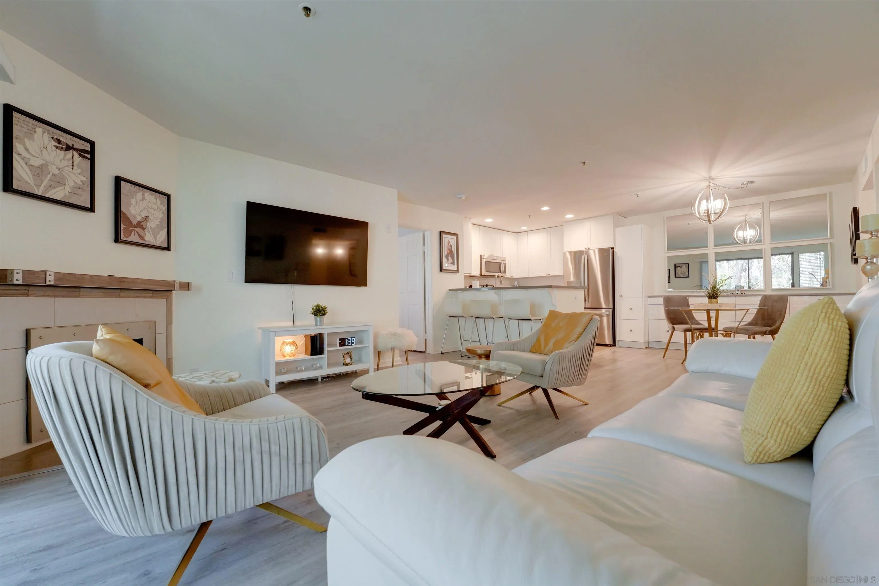 5745 Friars Road, Unit 107 San Diego, CA 92110 - Photo 7 of 25 a living room with furniture and a flat screen tv