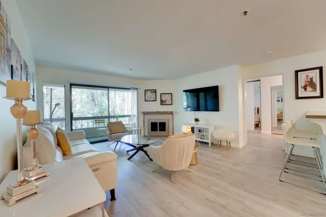 a living room with furniture fireplace and a flat screen tv