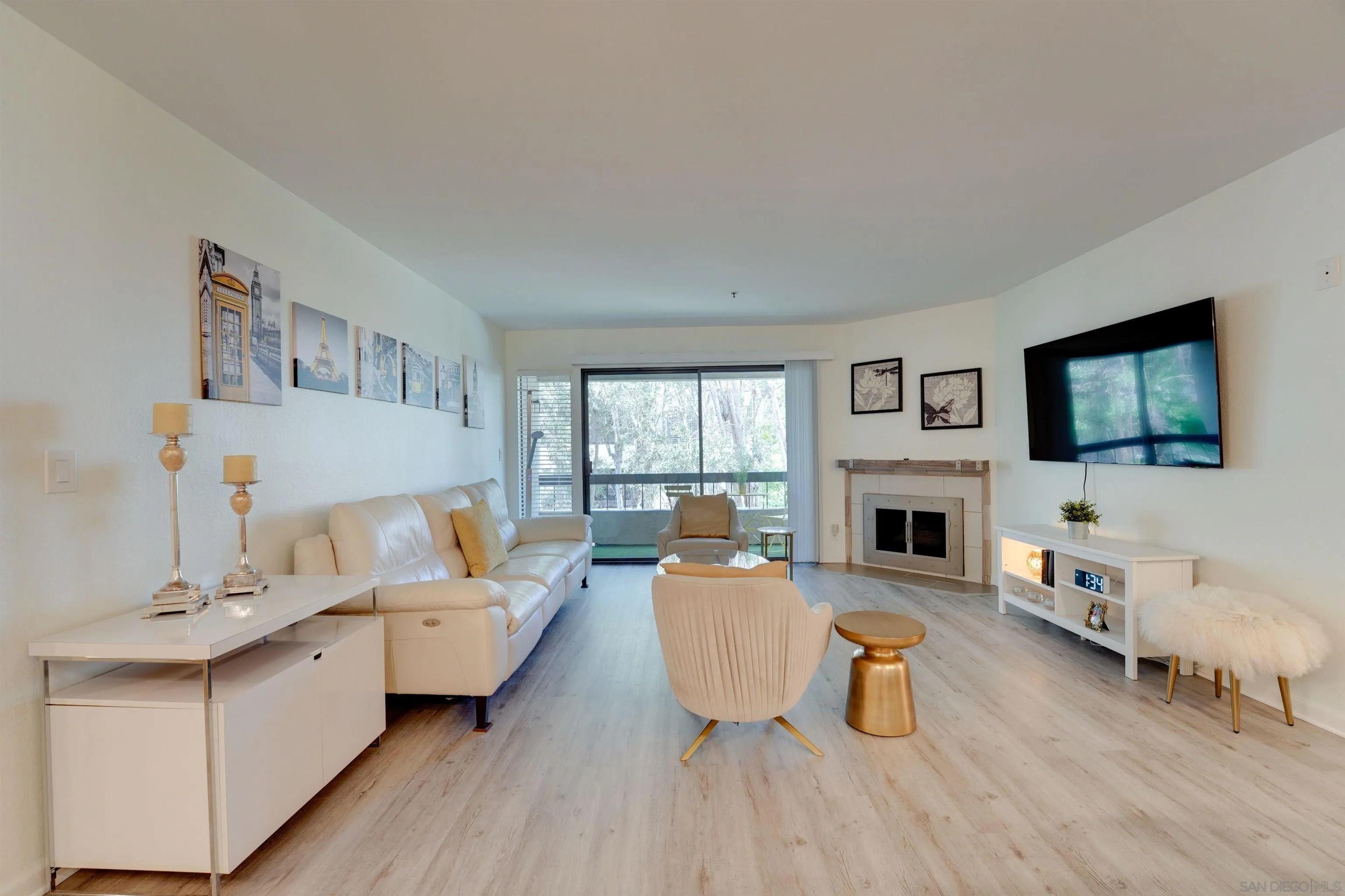 5745 Friars Road, Unit 107 San Diego, CA 92110 - Photo 9 of 25 a living room with furniture fireplace and flat screen tv