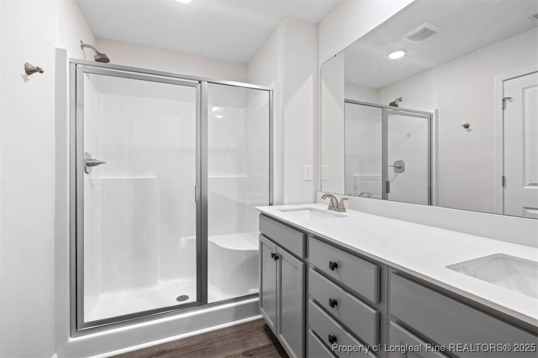 229 Ruritan Drive Fayetteville, NC 28314 - Photo 11 of 16 a bathroom with a shower sink and mirror