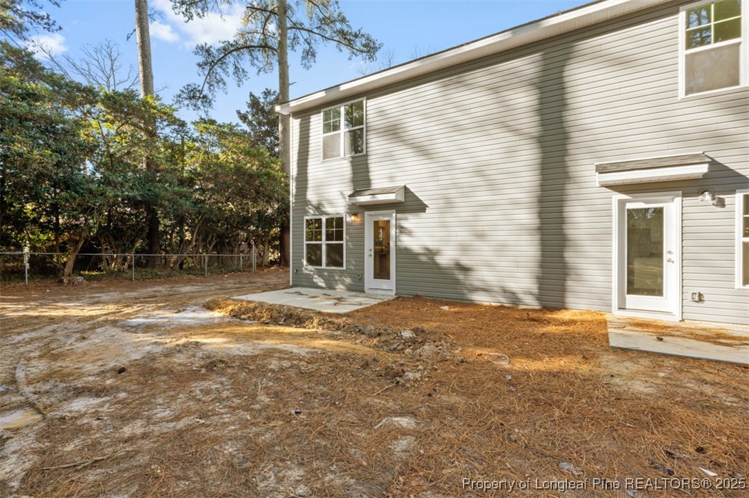 229 Ruritan Drive Fayetteville, NC 28314 - Photo 2 of 16 a backyard of a house with large trees and plants