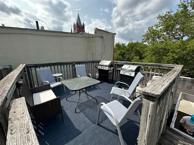 a view of roof deck with furniture