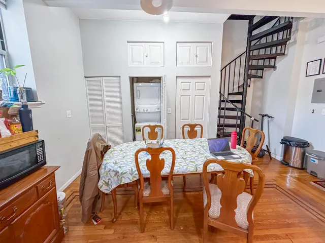 a view of a dining room with furniture and rug
