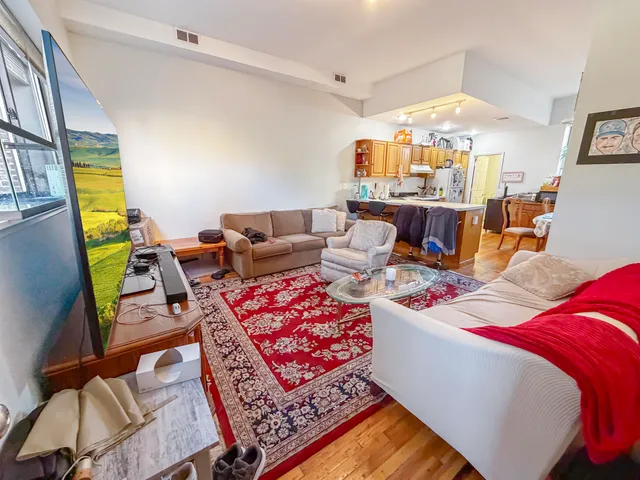 a living room with lots of furniture and a chandelier
