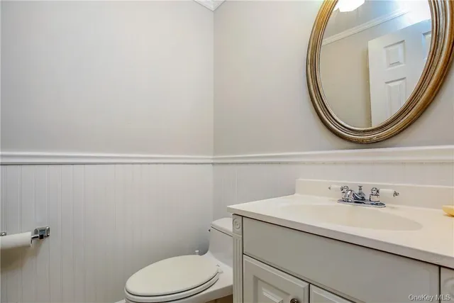 a bathroom with a sink mirror and toilet