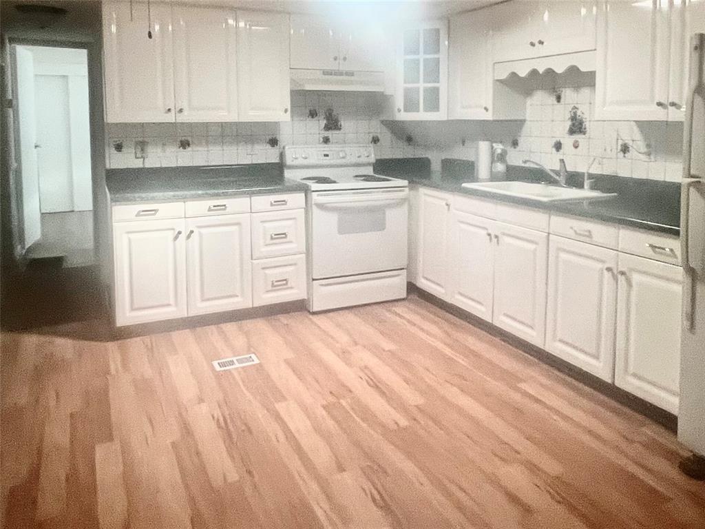 240 Rue De Fontaine Tavares, FL 32778 - Photo 20 of 43 a kitchen with a sink cabinets stainless steel appliances and a window