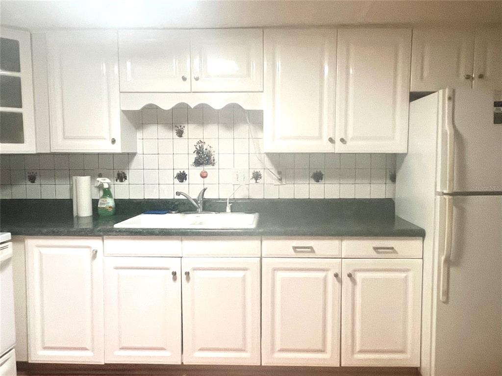 240 Rue De Fontaine Tavares, FL 32778 - Photo 22 of 43 a kitchen with a cabinets and window