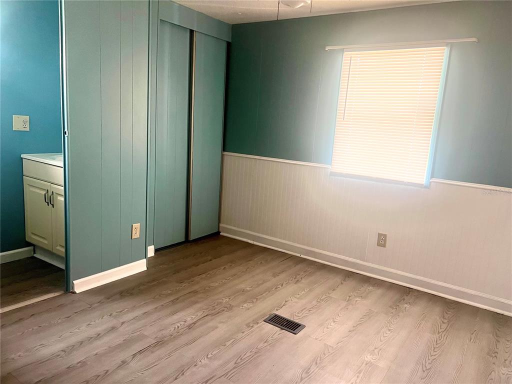 240 Rue De Fontaine Tavares, FL 32778 - Photo 28 of 43 an empty room with wooden floor and windows