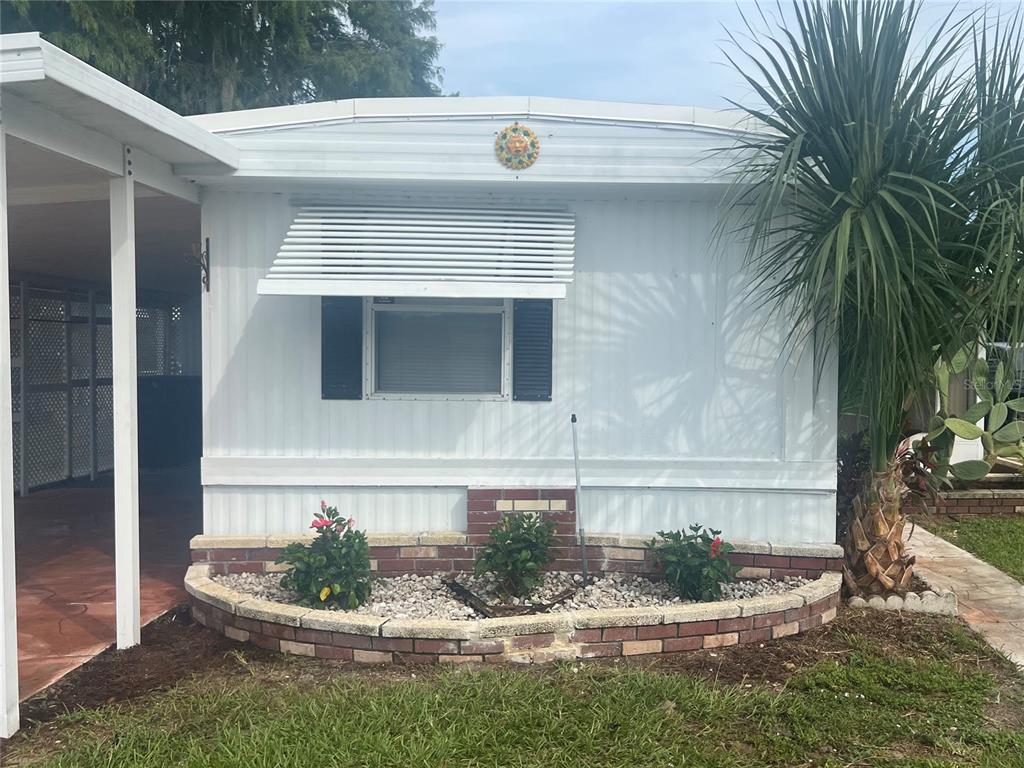 240 Rue De Fontaine Tavares, FL 32778 - Photo 4 of 43 a front view of a house with a yard