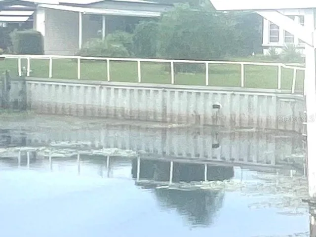 a view of a living room and floor to ceiling window or kitchen