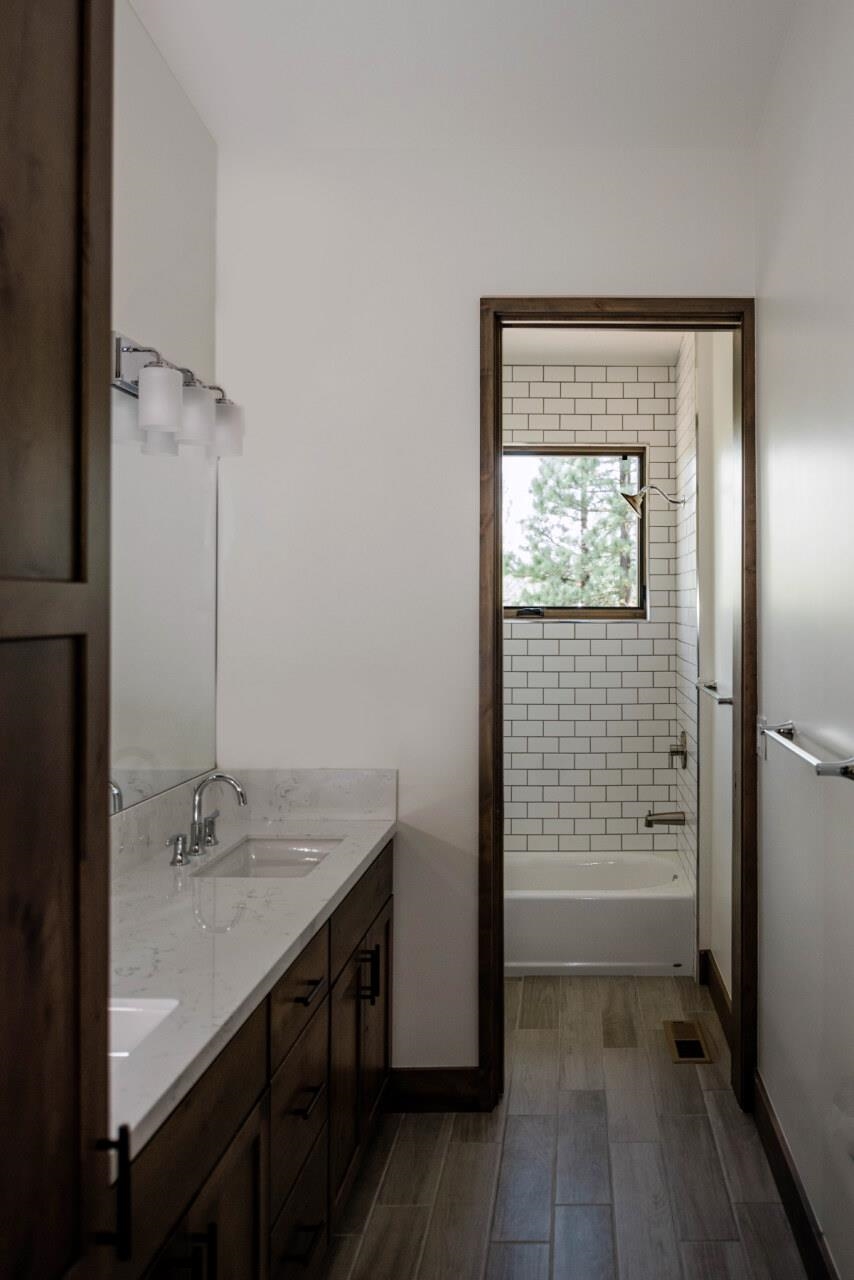 1391 Eagle Feather Portola, CA 96122 - Photo 24 of 28 a bathroom with a granite countertop sink a toilet and shower