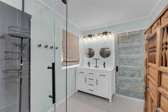 a bathroom with a shower a sink and a mirror