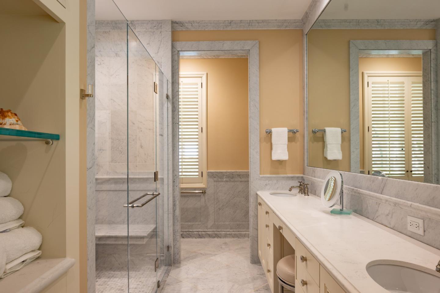 1500 Viscaino Road Pebble Beach, CA 93953 - Photo 9 of 16 a bathroom with a granite countertop sink toilet and shower