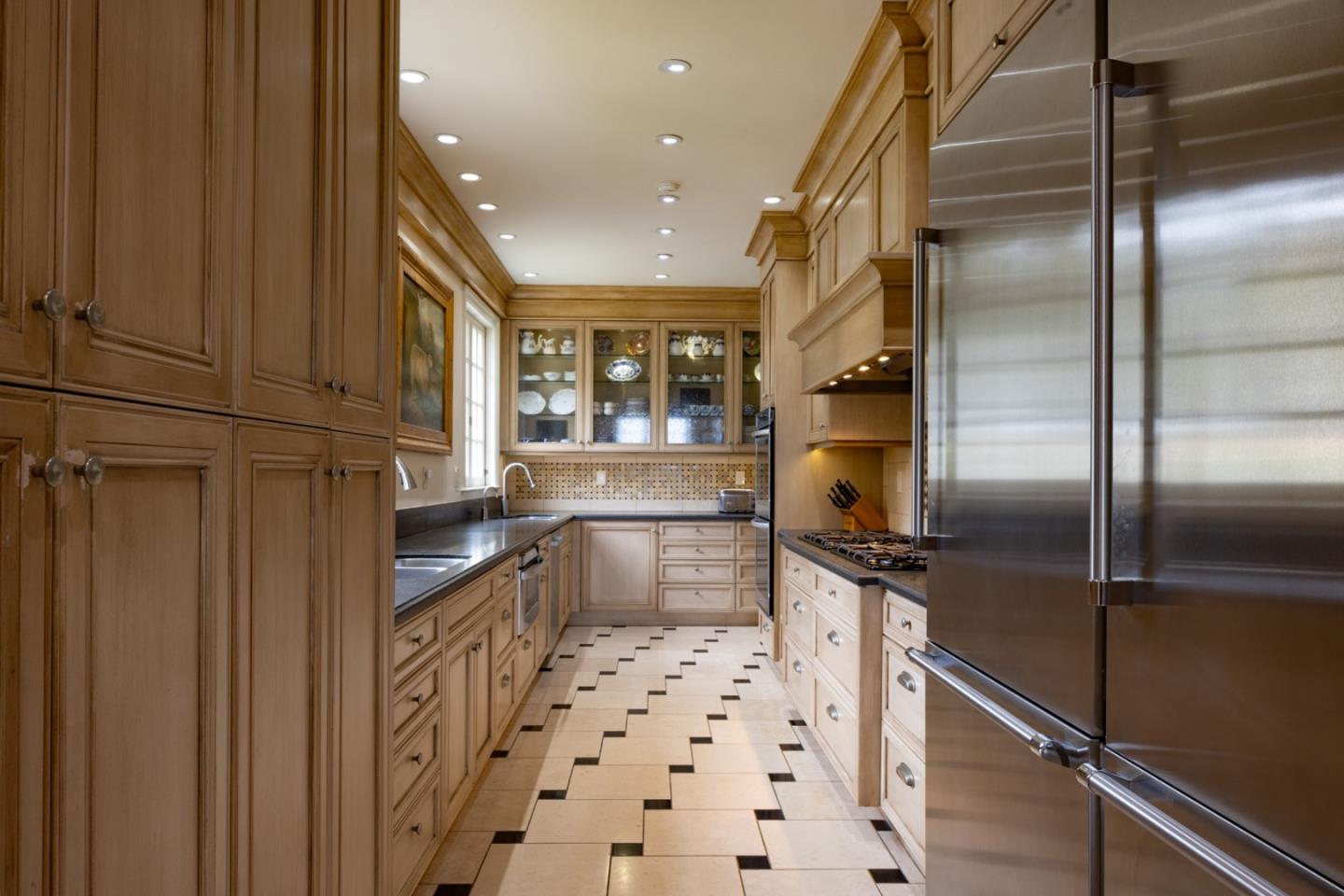 1500 Viscaino Road Pebble Beach, CA 93953 - Photo 10 of 16 a kitchen with granite countertop stainless steel appliances a counter top space and cabinets