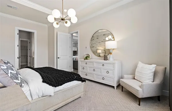 a bedroom with a bed and a chair