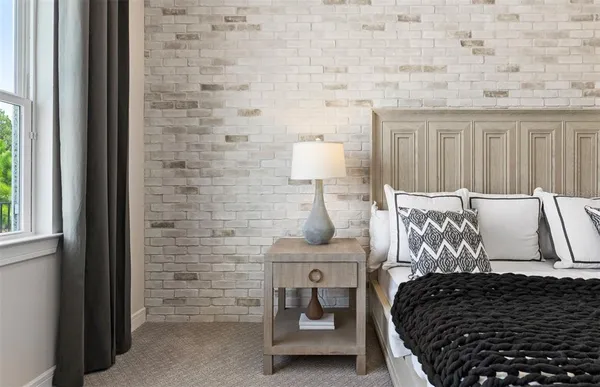 a bedroom with bed a chandelier and a window