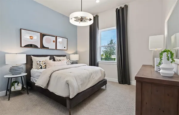 a bedroom with a bed and a lamp