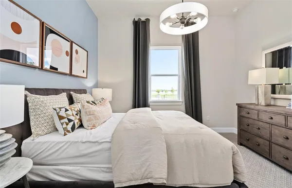 a bedroom with a bed and a chandelier