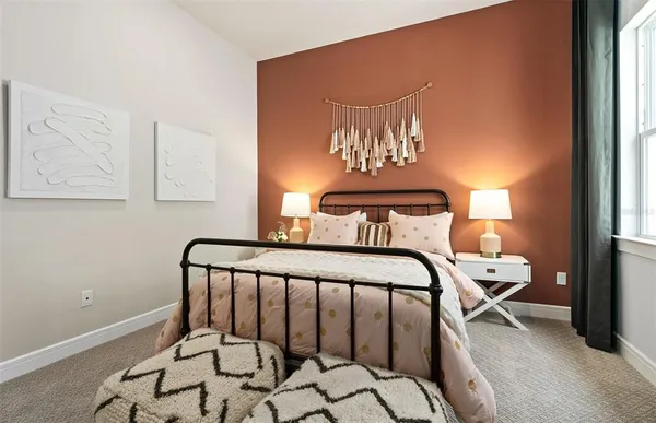 a bedroom with a bed and a large window