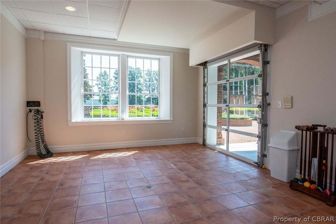 19607 White Oak Road Sutherland, VA 23885 - Photo 32 of 50 Hobby Room has hose (2) and center floor drain. The glass automatic overhead door opens to the rear porch. Drive in your ATV or golf cart with flowers from the green house.