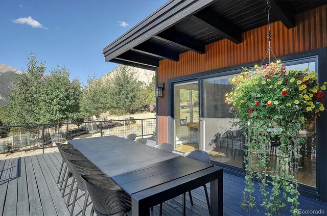 a view of balcony with a table and chairs