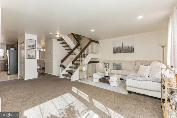a living room with furniture and stairs