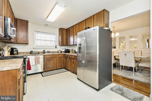 a kitchen with stainless steel appliances a refrigerator sink and cabinets