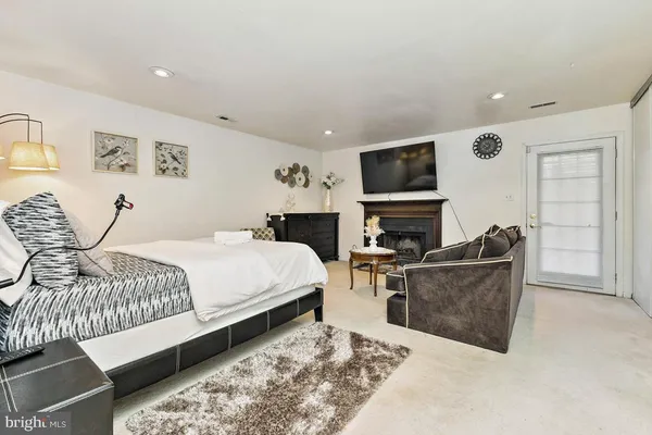 a living room with furniture a flat screen tv and a fireplace