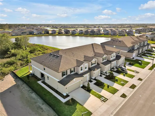 a view of a white house with swimming pool in front of it