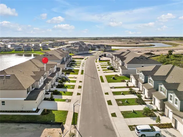 a view of a swimming pool with a lawn chairs and potted plants