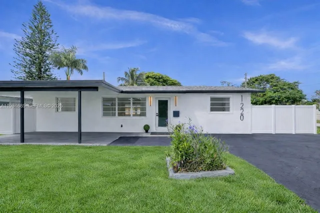 a view of a house with a yard and a garden