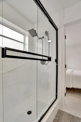 a bathroom with a glass shower door